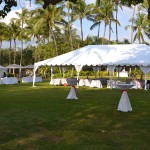 large white tent rental positioned on a lawn for an upcoming event