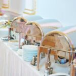 A buffet is set up on a table with a white tablecloth